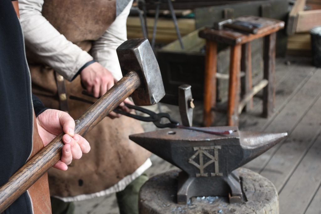 Father and son small business manual metalworking. a small blacksmith shop