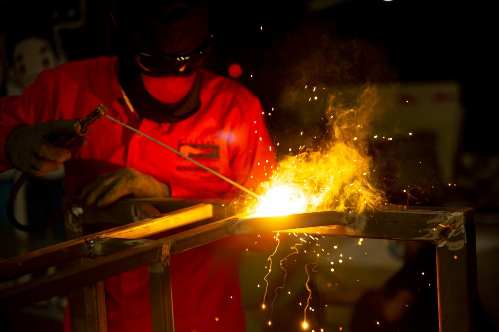 Workers are welding a steel frame.
