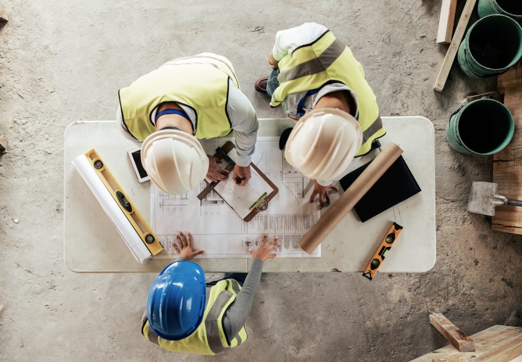 Architect, engineer and teamwork with blueprint from above on a building or contractor project. Bui